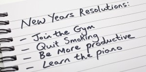 New Year's Resolutions written on a note pad.